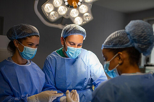 Surgeons operating in theatre