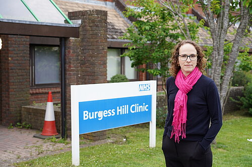 Alison Bennett next to NHS Building Sign