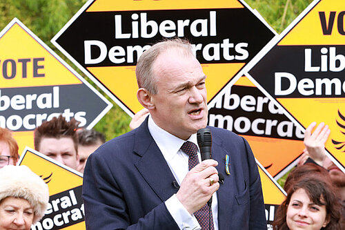 Ed Davey in front of a crowd holding Liberal Democrat posters