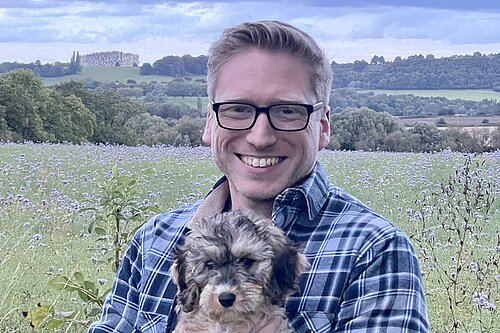 Dan Boatright-Greene holding a small dog