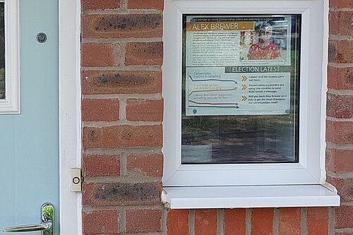 A Lib Dem leaflet displayed in a window