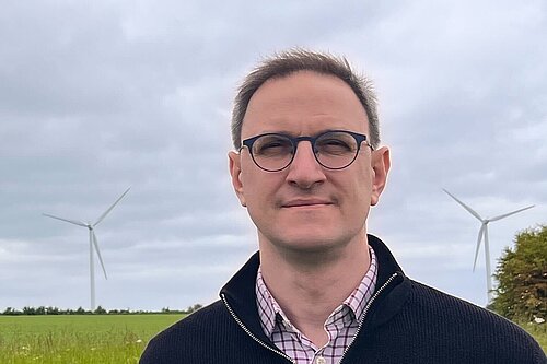 Ian Sollom standing in a field