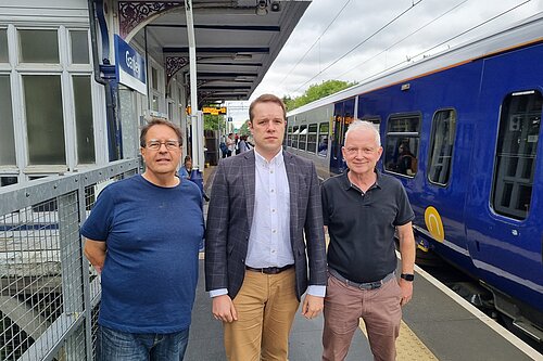 Tom and Councillors at train station with northern rail train in background