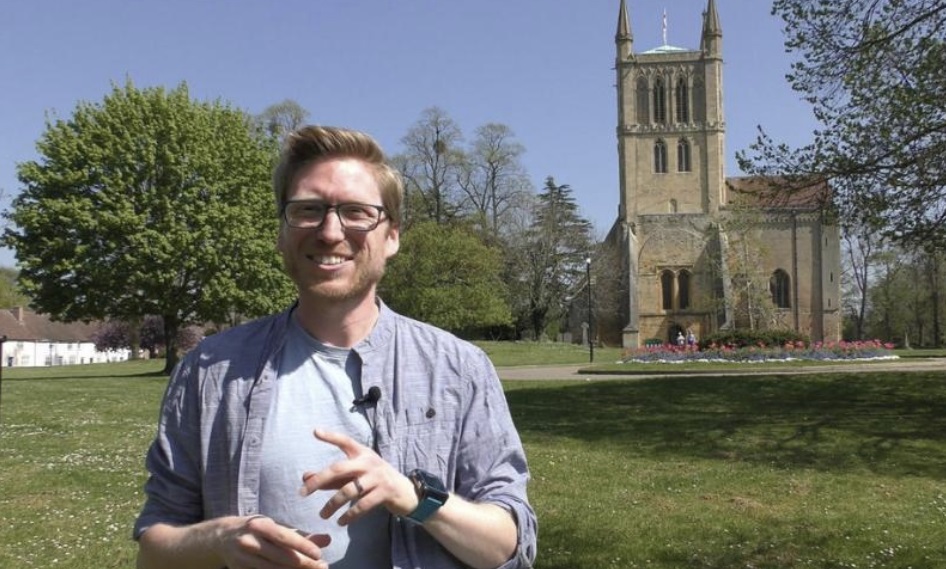 Dan Boatright-Greene standing in front of Pershore Abbey